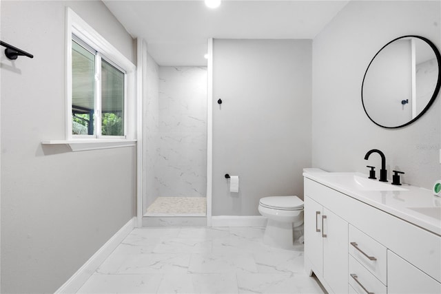 bathroom featuring a tile shower, toilet, and vanity