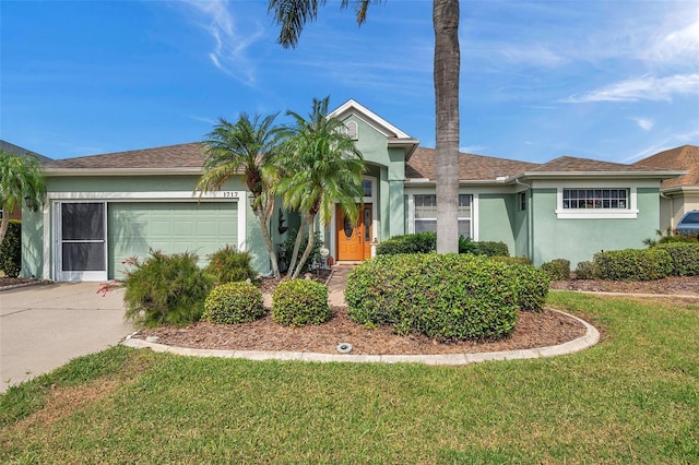 view of front of home with a front yard and a garage