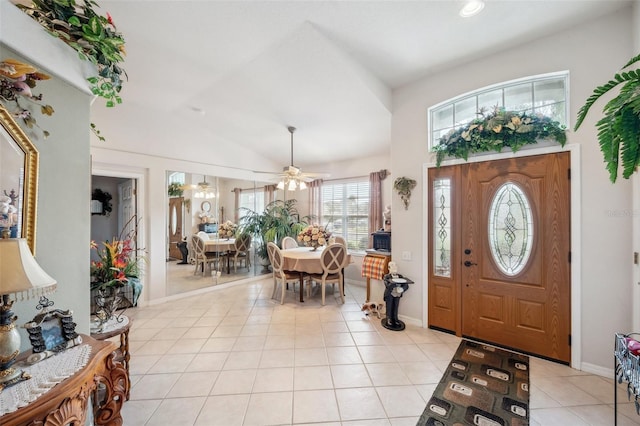 tiled foyer entrance with ceiling fan and lofted ceiling