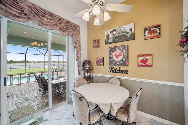 tiled dining space featuring ceiling fan