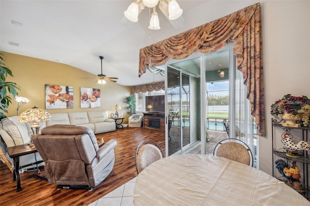 dining area featuring ceiling fan, vaulted ceiling, and hardwood / wood-style floors