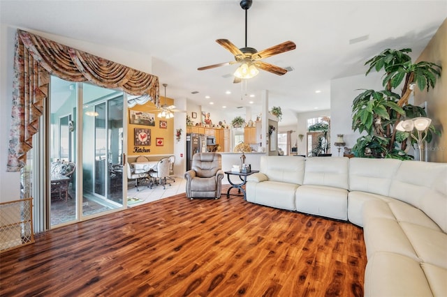 living room featuring wood-type flooring and ceiling fan