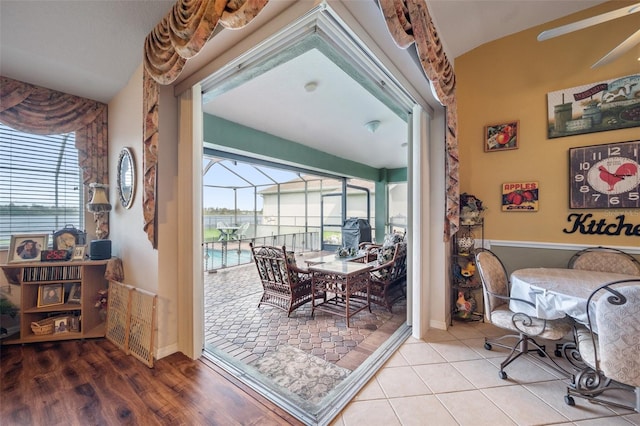 dining area with a healthy amount of sunlight, vaulted ceiling, and light wood-type flooring