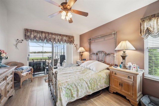 bedroom with ceiling fan, multiple windows, and light hardwood / wood-style floors