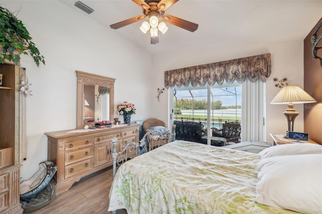 bedroom with vaulted ceiling, access to exterior, light hardwood / wood-style floors, and ceiling fan