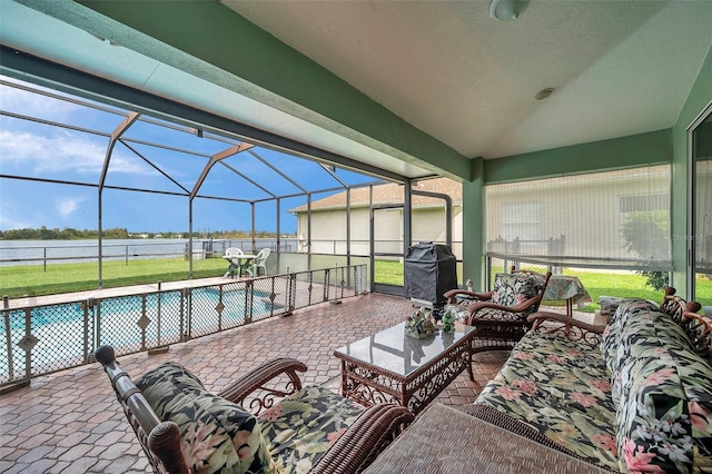 view of patio featuring a fenced in pool, area for grilling, outdoor lounge area, and glass enclosure