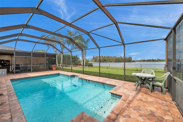 view of swimming pool with a lawn, a patio, a water view, and glass enclosure