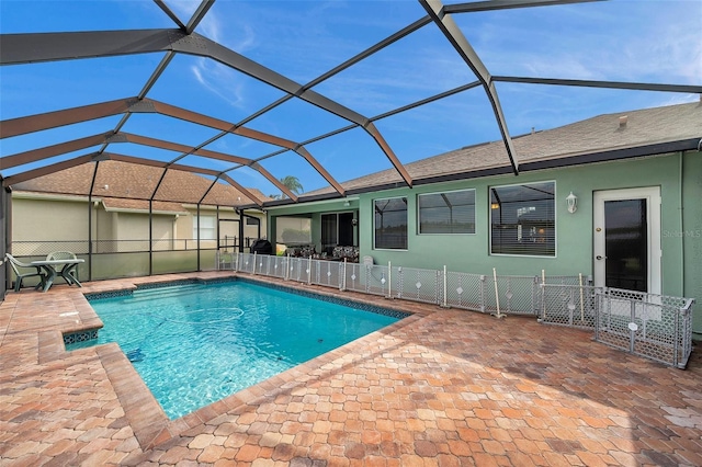 view of pool with a patio and a lanai