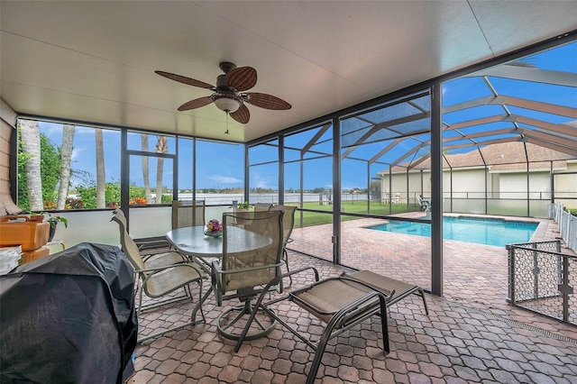 unfurnished sunroom featuring vaulted ceiling, a pool, and ceiling fan