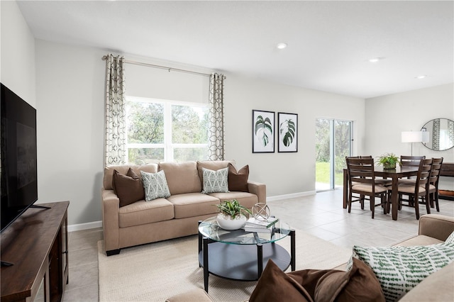 living room featuring light tile patterned floors and a wealth of natural light