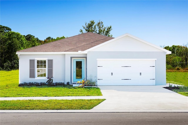 view of front of property with a front lawn and a garage