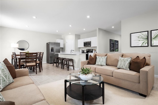 living room with sink and light tile patterned floors