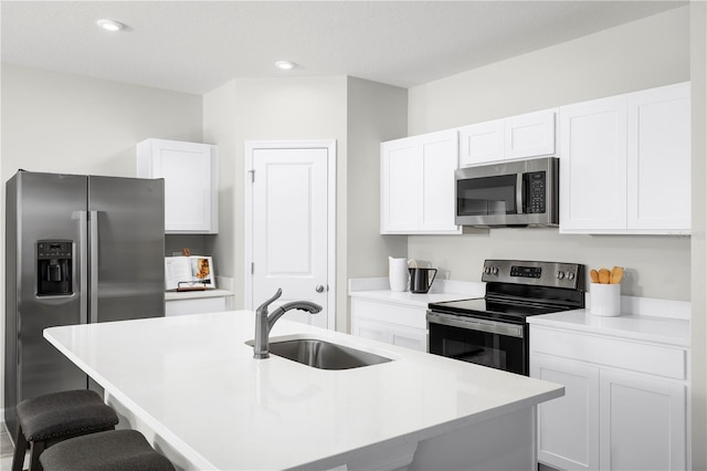 kitchen featuring appliances with stainless steel finishes, sink, and an island with sink