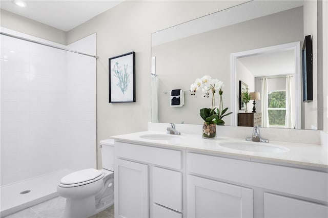 bathroom with toilet, walk in shower, vanity, and tile patterned flooring