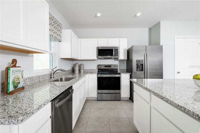 kitchen with white cabinetry, appliances with stainless steel finishes, and sink