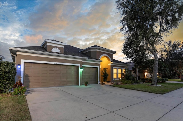 view of front of home featuring a yard and a garage