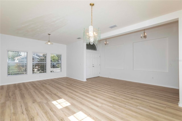 interior space featuring light hardwood / wood-style floors and a chandelier