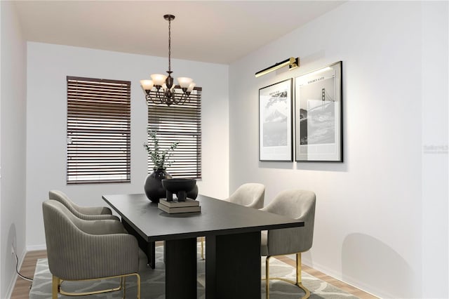 dining room featuring hardwood / wood-style flooring and an inviting chandelier