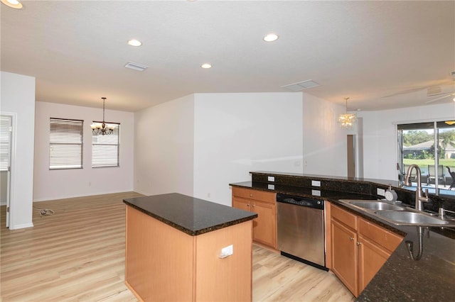 kitchen with sink, a center island, decorative light fixtures, light wood-type flooring, and stainless steel dishwasher