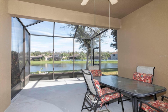 sunroom / solarium featuring a water view