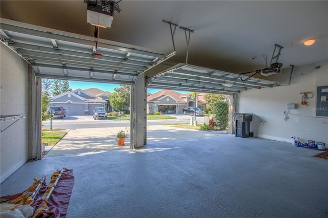 garage featuring a garage door opener and electric panel