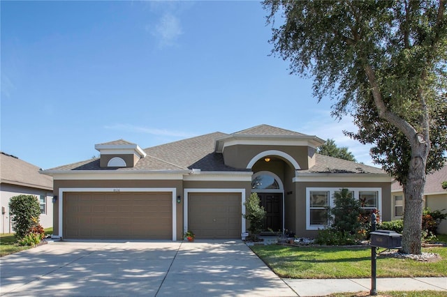 view of front of home featuring a front yard and a garage