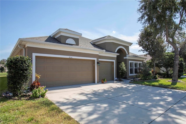 view of front of house with a front yard and a garage