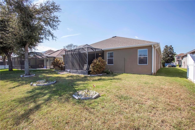 exterior space featuring a yard and glass enclosure