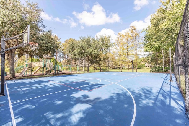 view of basketball court with a playground