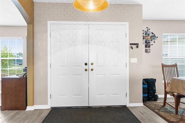 entrance foyer with hardwood / wood-style flooring, a textured ceiling, and plenty of natural light