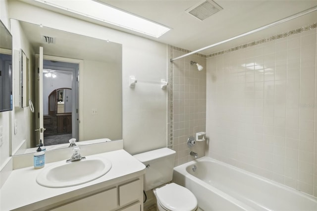 bathroom featuring visible vents, shower / bath combination, toilet, and vanity