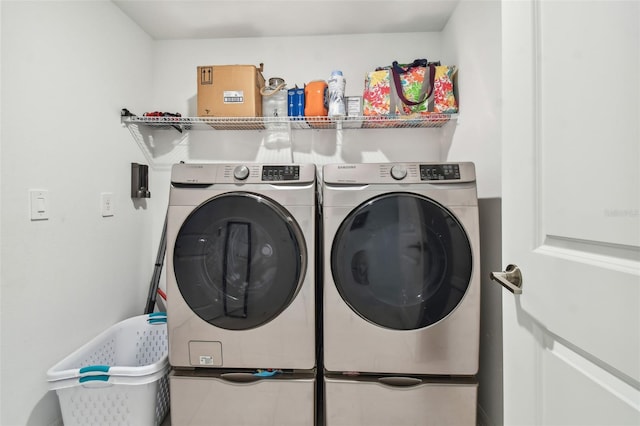 clothes washing area featuring washer and clothes dryer