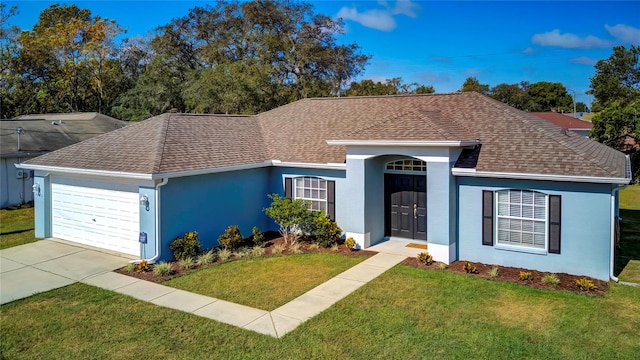 ranch-style house featuring a front lawn and a garage