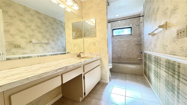 full bathroom with vanity, tile patterned floors, tiled shower / bath combo, and toilet