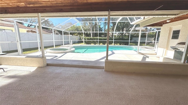 view of swimming pool with an in ground hot tub, glass enclosure, and a patio area