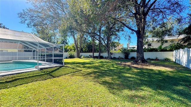 view of yard with a lanai and a fenced in pool