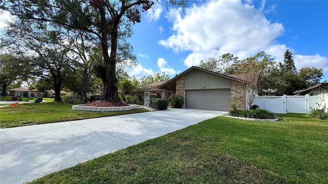 view of front of property with a garage and a front lawn