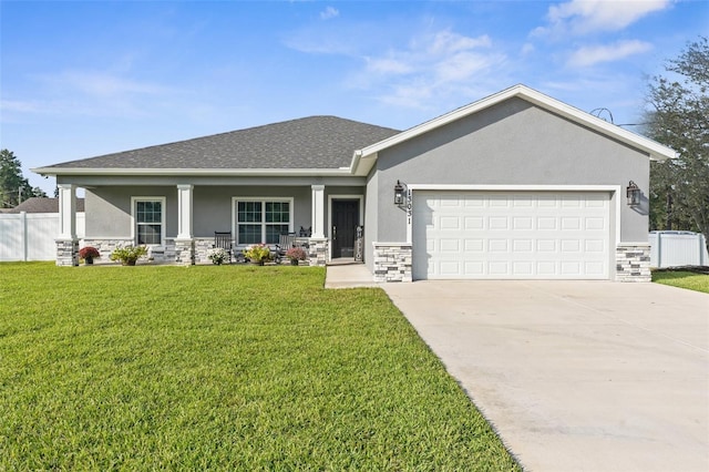 view of front facade featuring a garage, a front yard, and covered porch