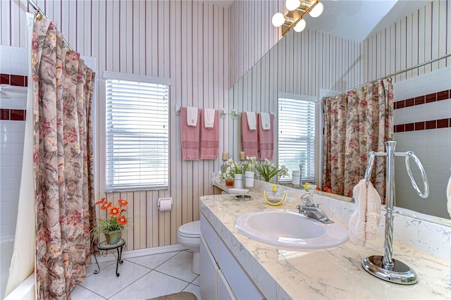 full bathroom featuring a wealth of natural light, vanity, toilet, and tile patterned flooring