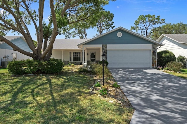 ranch-style house featuring a front lawn and a garage