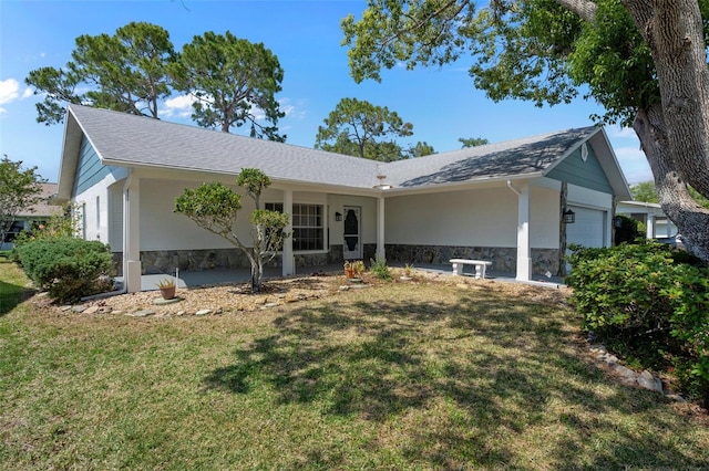 ranch-style home with a front yard and a garage