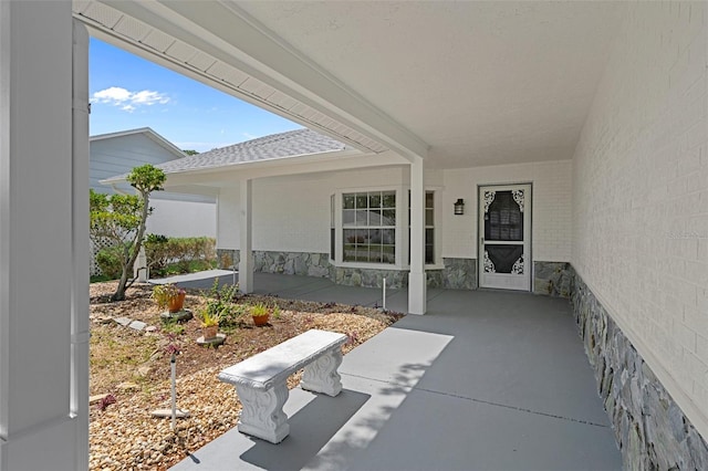 view of exterior entry featuring a patio