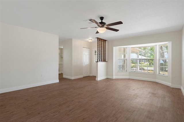 unfurnished living room featuring dark hardwood / wood-style floors and ceiling fan