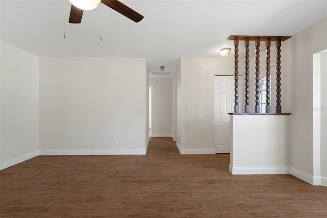 unfurnished room featuring dark hardwood / wood-style floors and ceiling fan