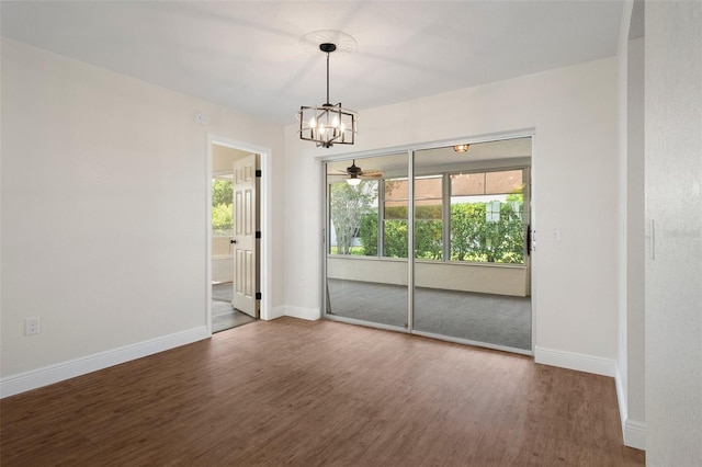 unfurnished room featuring hardwood / wood-style flooring and ceiling fan with notable chandelier