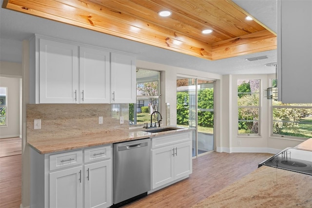 kitchen featuring sink, dishwasher, light wood-type flooring, white cabinets, and light stone counters