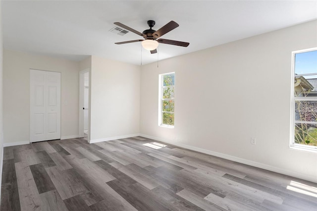 spare room with ceiling fan and wood-type flooring