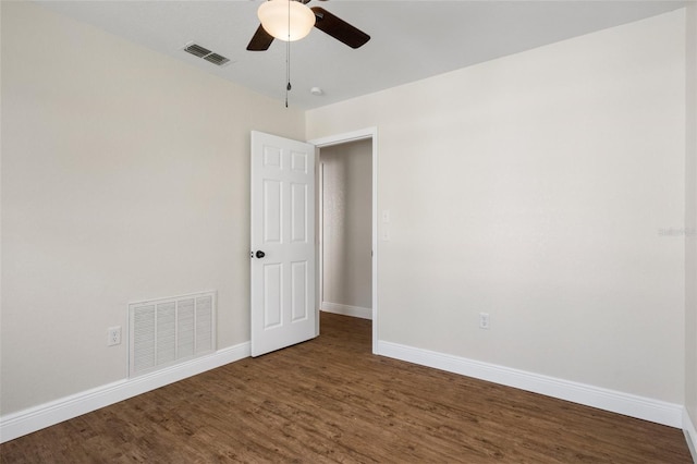 unfurnished room with ceiling fan and dark hardwood / wood-style flooring