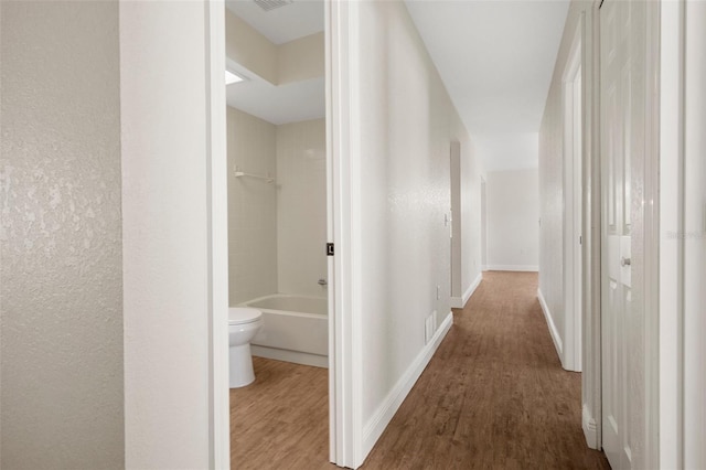 hallway with wood-type flooring