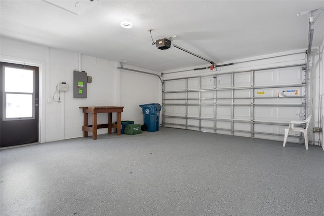 garage with a garage door opener and electric panel